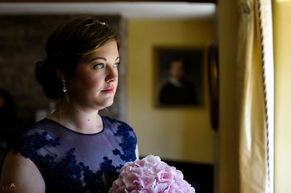 bridesmaid gazes out of window