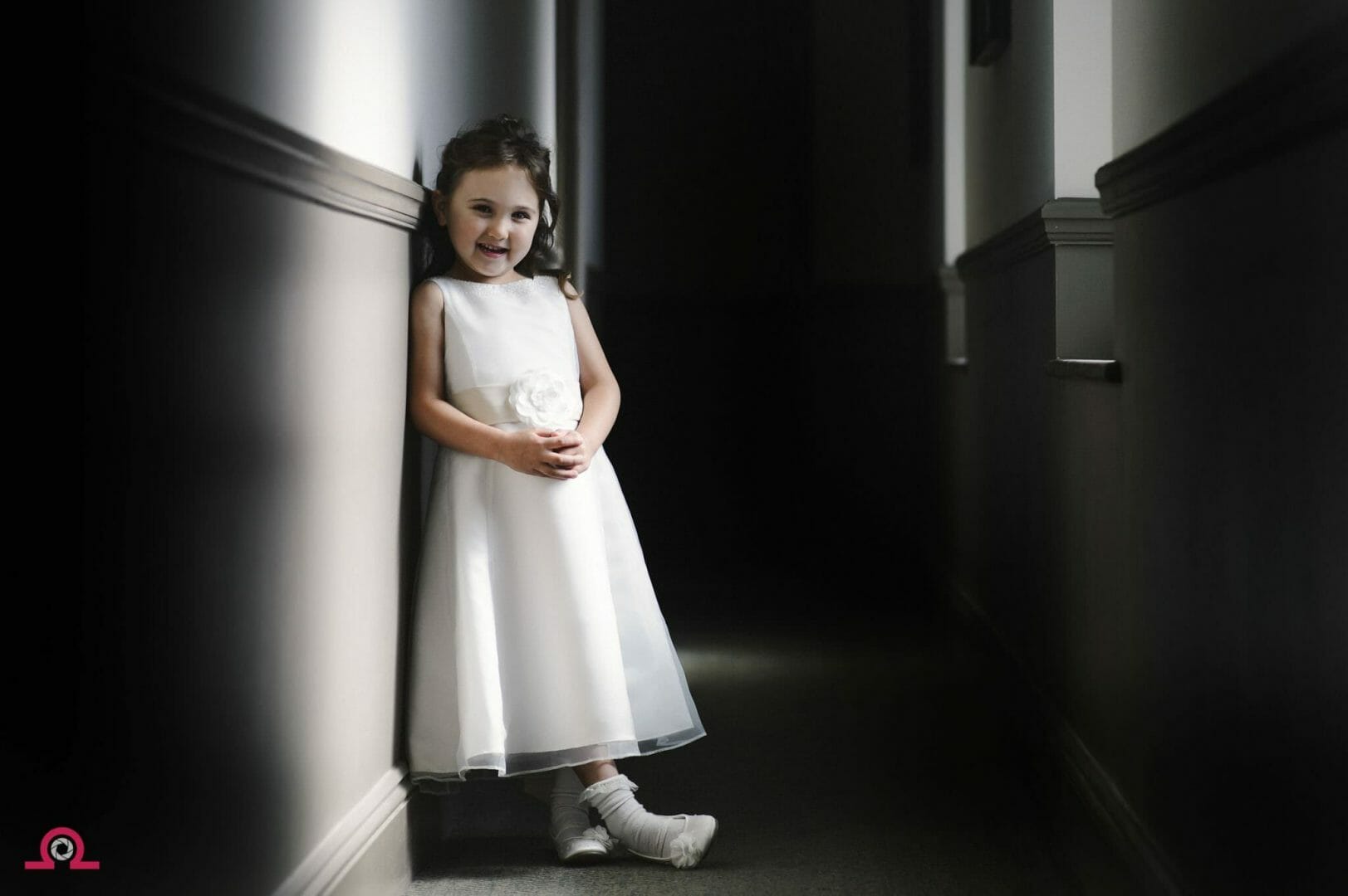 flowergirl waits by a hallway window in hotel Du Vin Poole