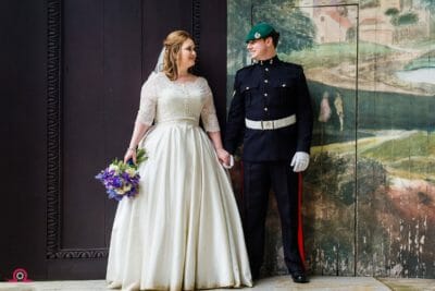 Bride and groom look at each other on the stage at their Larmer Tree Garden wedding