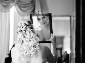 bride looks in mirror - North Cadbury Court Wedding photographer