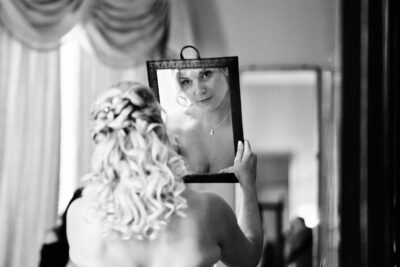 bride looks in mirror - North Cadbury Court Wedding photographer