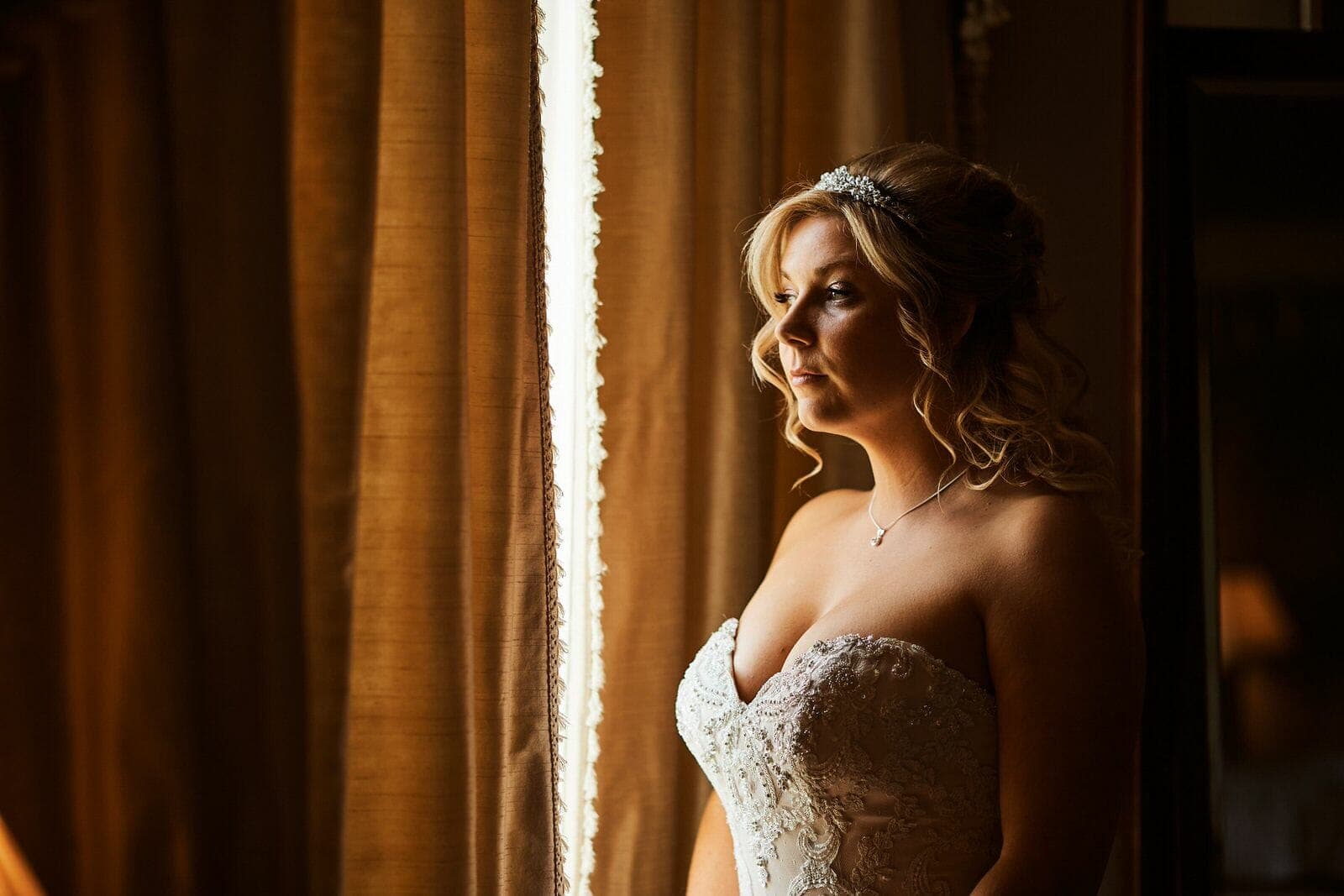 bride in window light - North Cadbury Court Wedding photographer