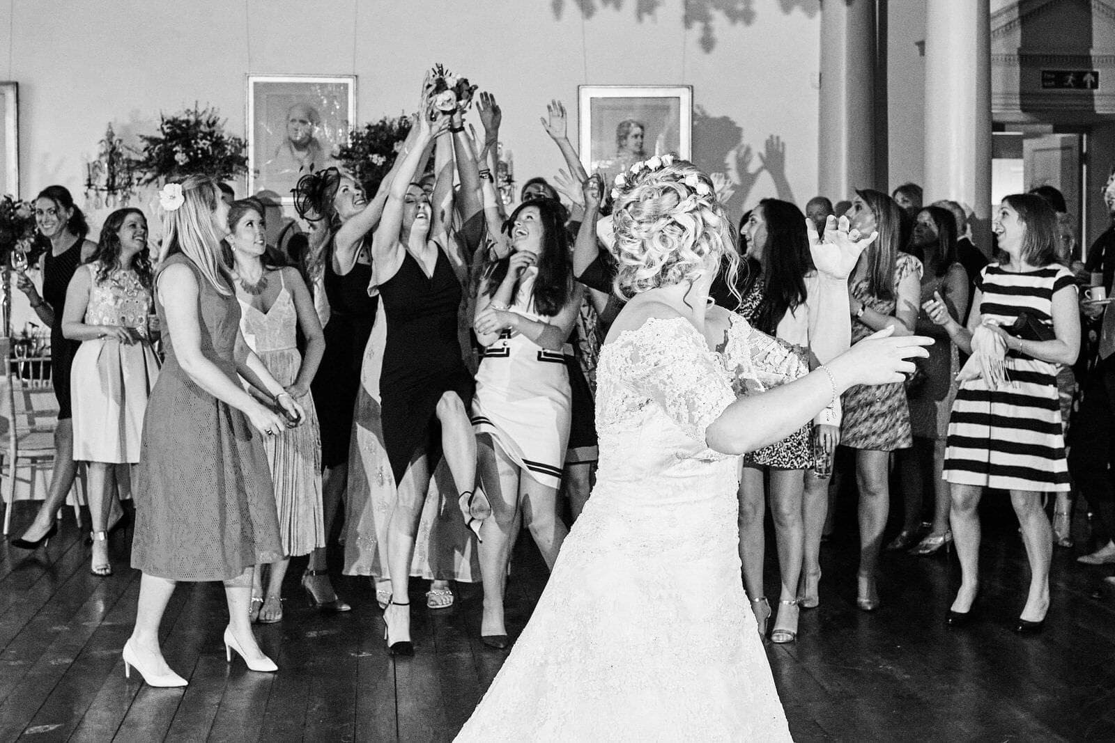 bride throws bouquet at North Cadbury Court Wedding