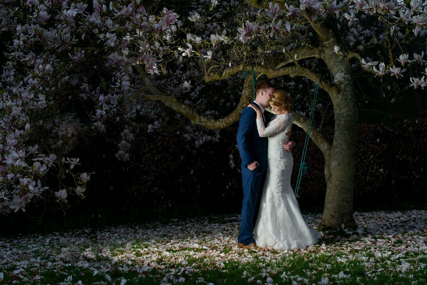 bride and groom under magnolia tree