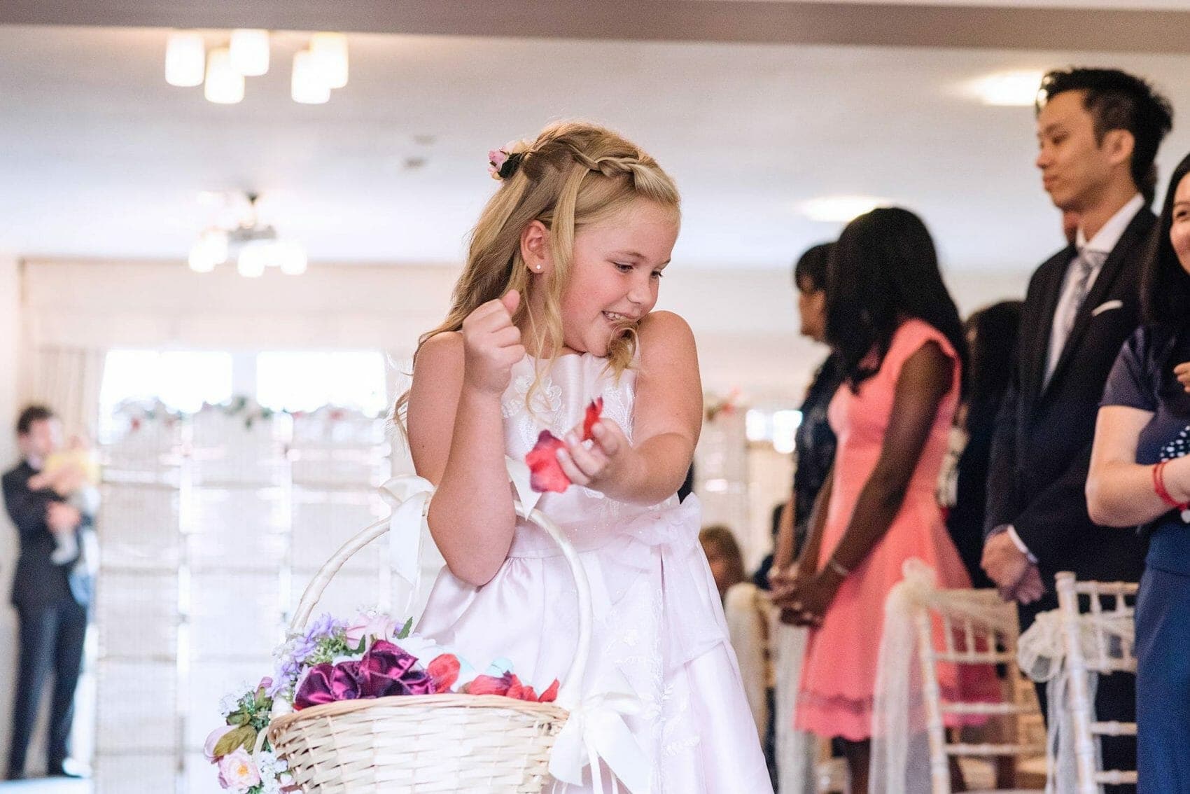 Flowergirl spreading petals at the italian villa wedding ceremony