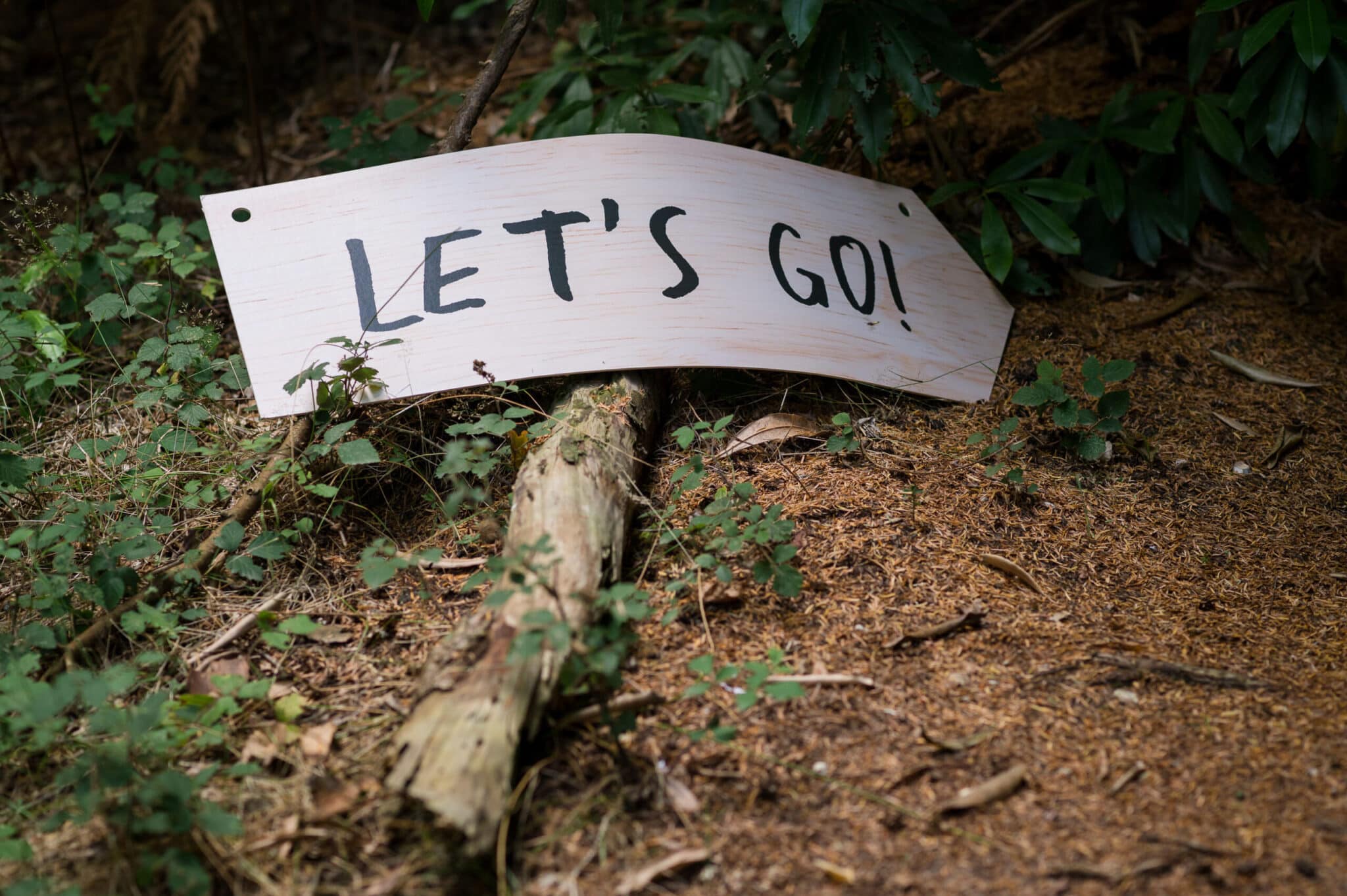 Sign saying ‘Lets Go’ at Weddings in the Wood in Hampshire