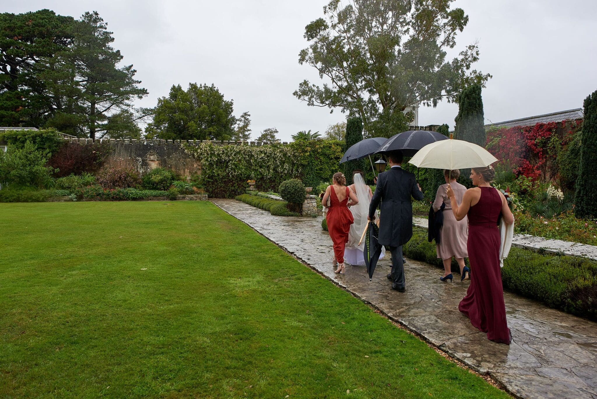 Wedding Party walking in the rain at Brownsea Island wedding