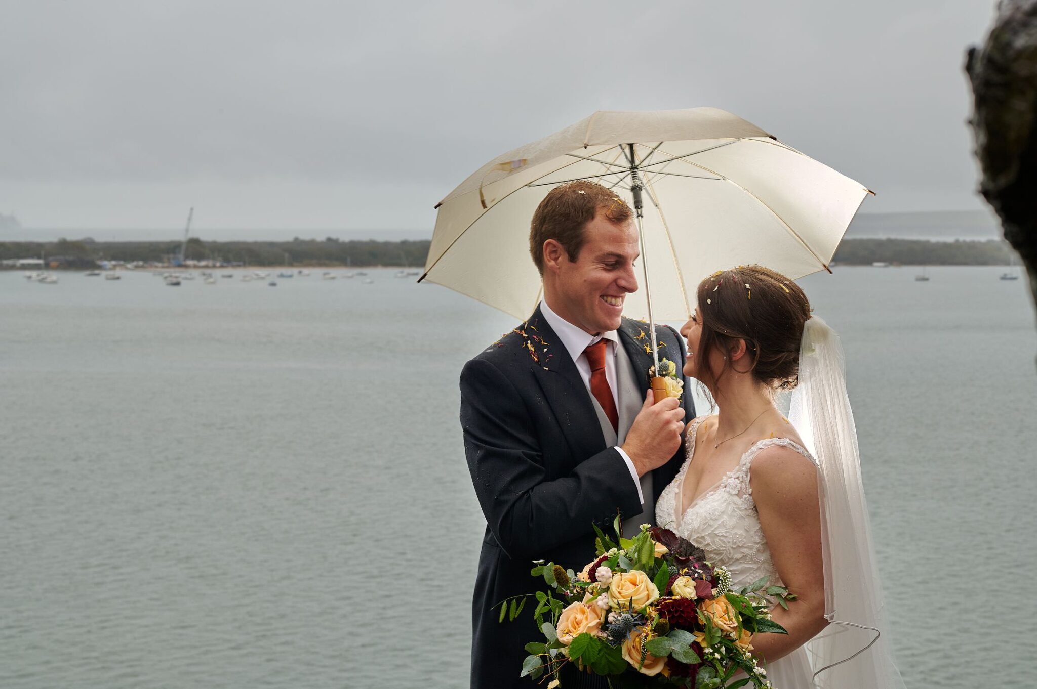 Bride and Grrom under umbrella