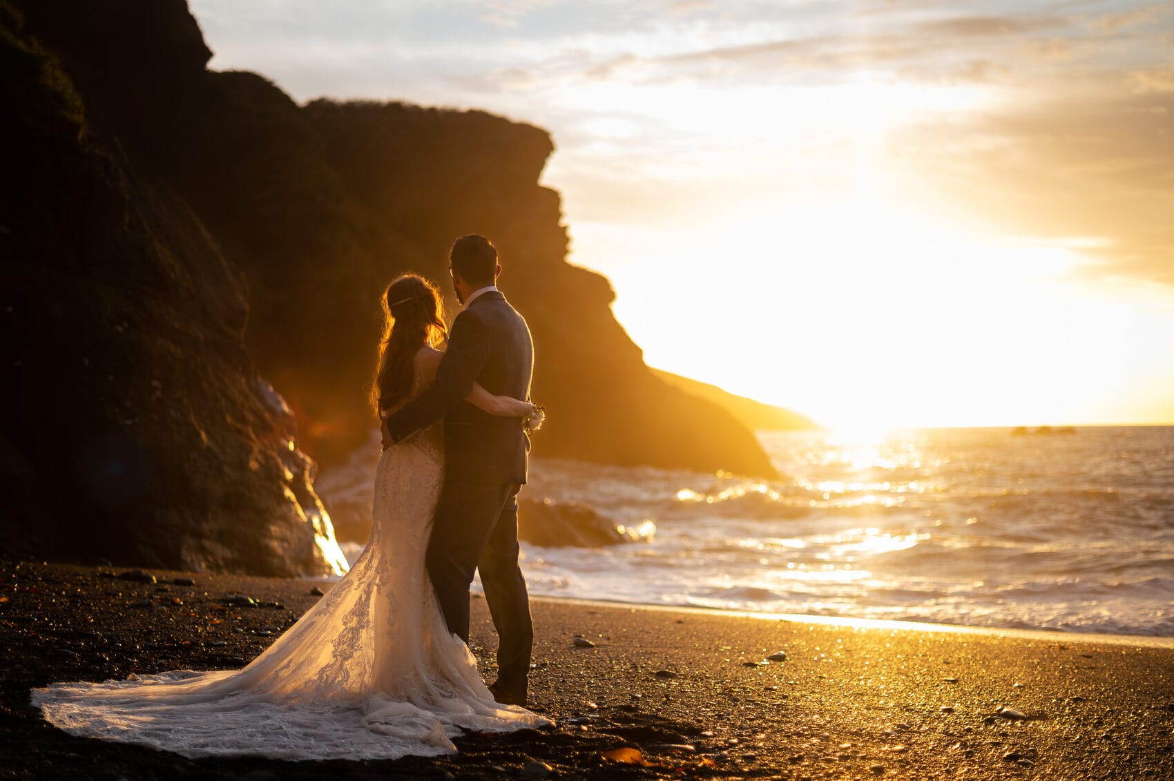 Sun setting on the bride and groom at Tunnels Beaches Wedding venue