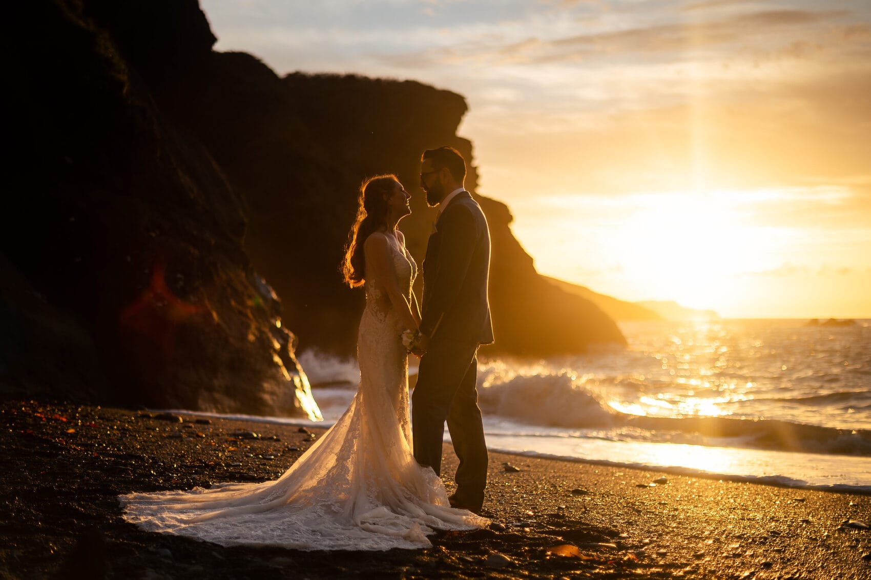 Golden hour portrait of the bride and groom at Tunnels Beaches Wedding venue