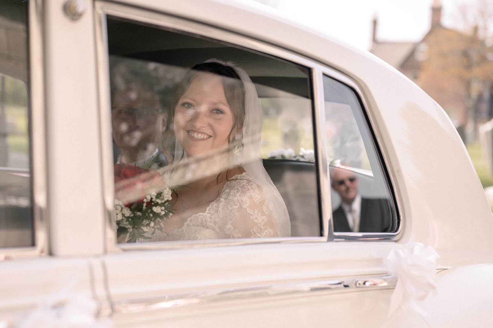 Bride ariving in clasic car at Christchurch Priory wedding ceremony