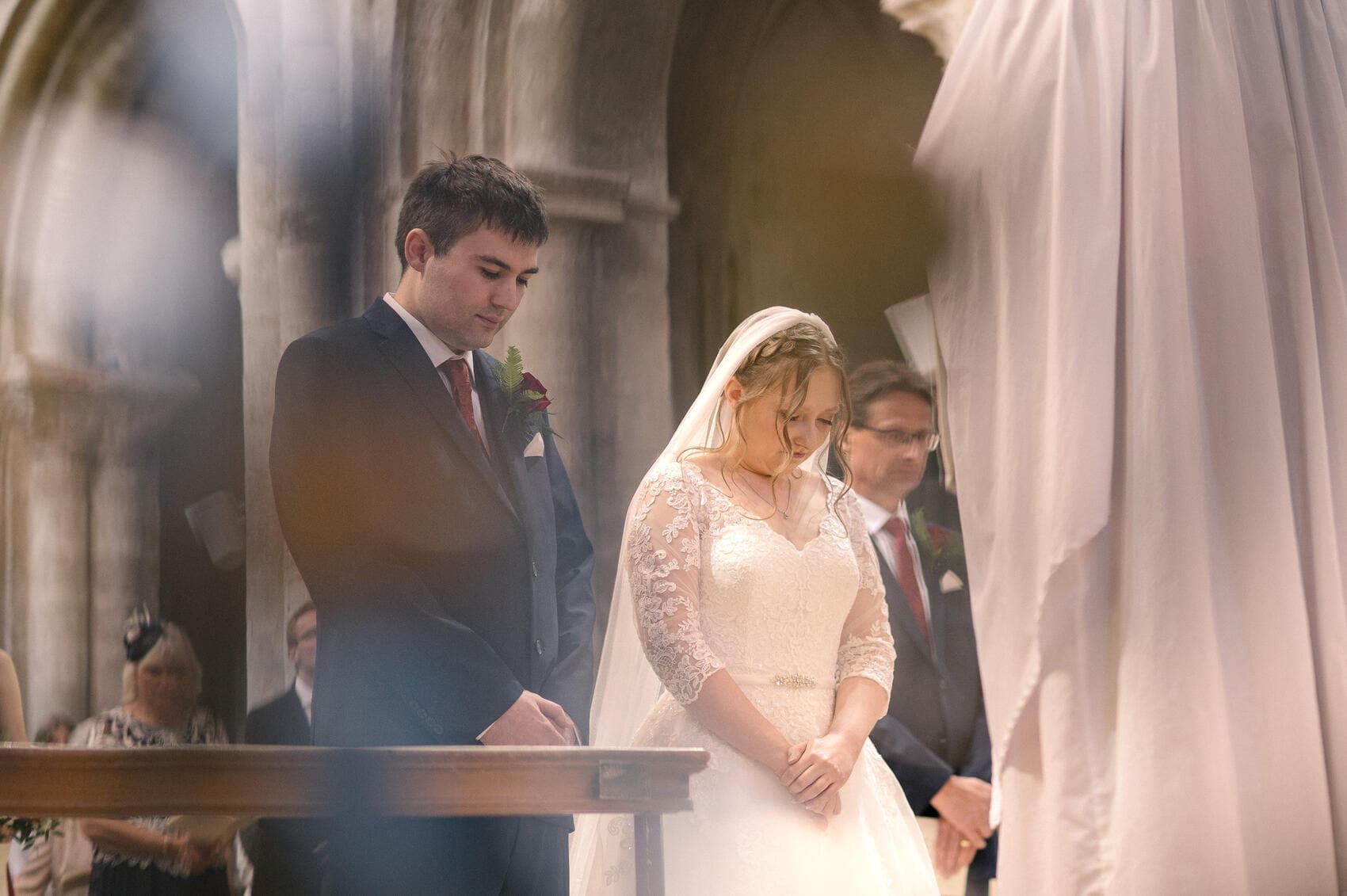 Bride and Groom standing at the Alter at Christchurch Priory wedding ceremony