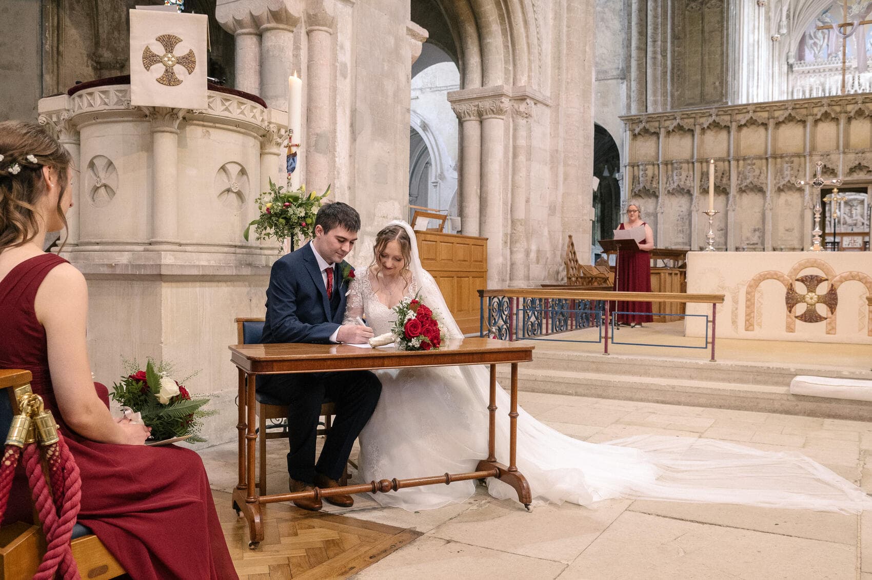 Signing the register at Christchurch Priory wedding ceremony