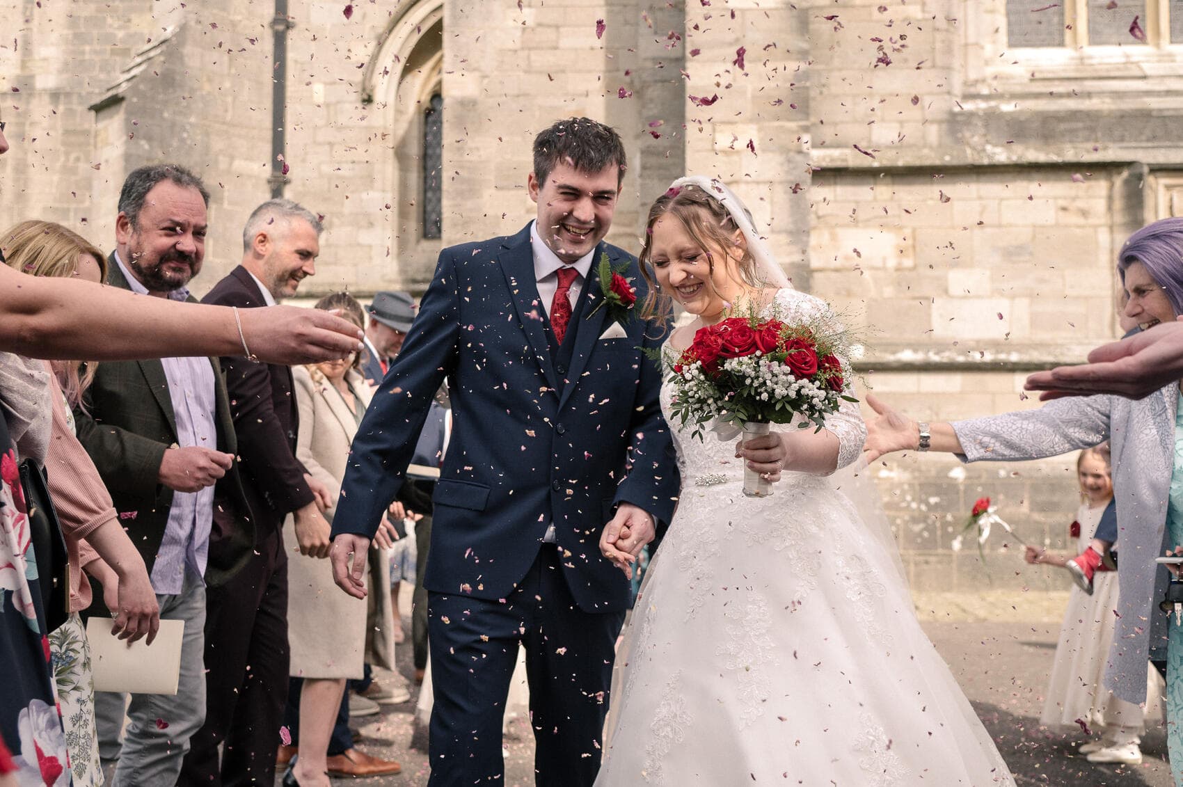 Confetti toss outside Christchurch Priory wedding ceremony