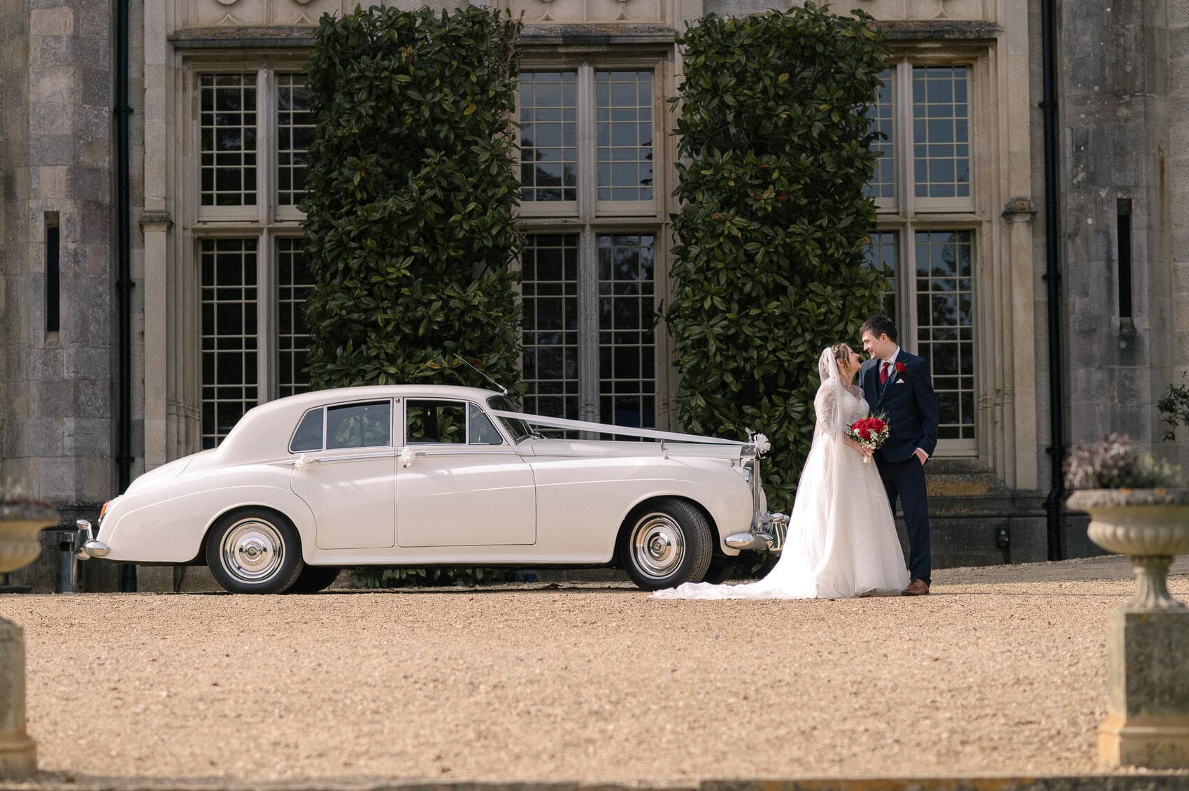 Bride and Groom with classic car at Highcliffe castle wedding