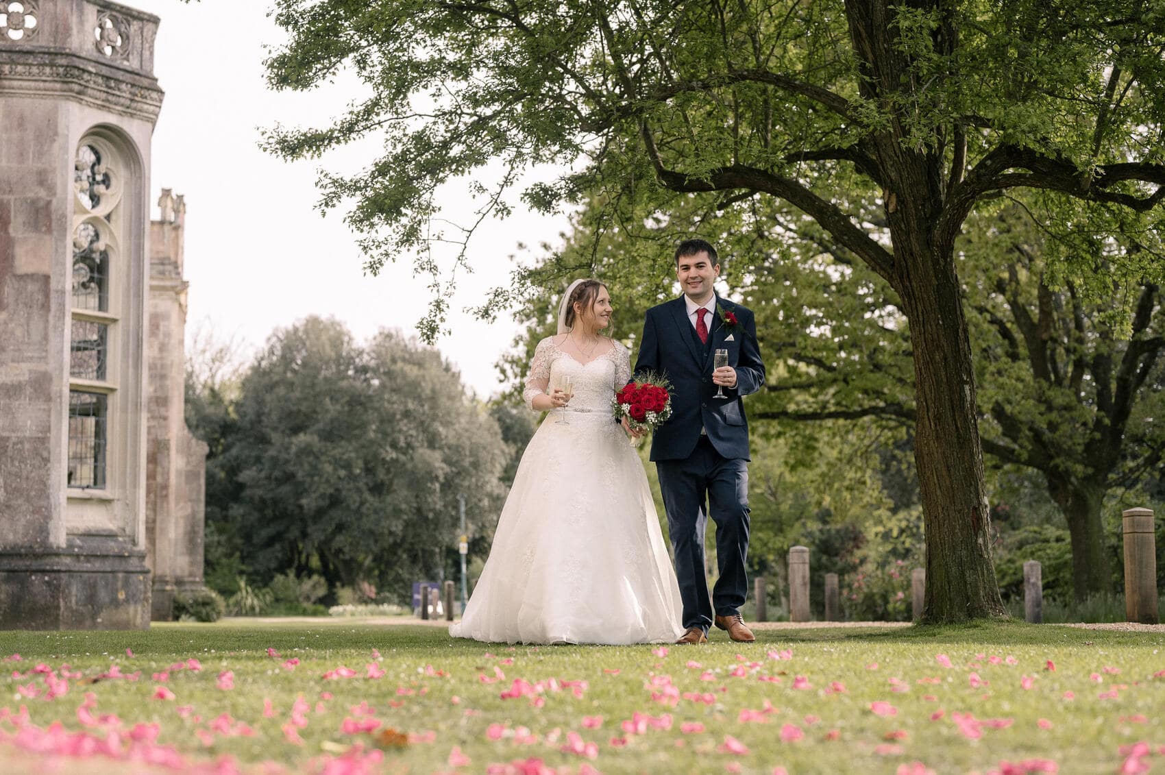 Bride and groom take a walk through the grounds of Highcliffe castle wedding