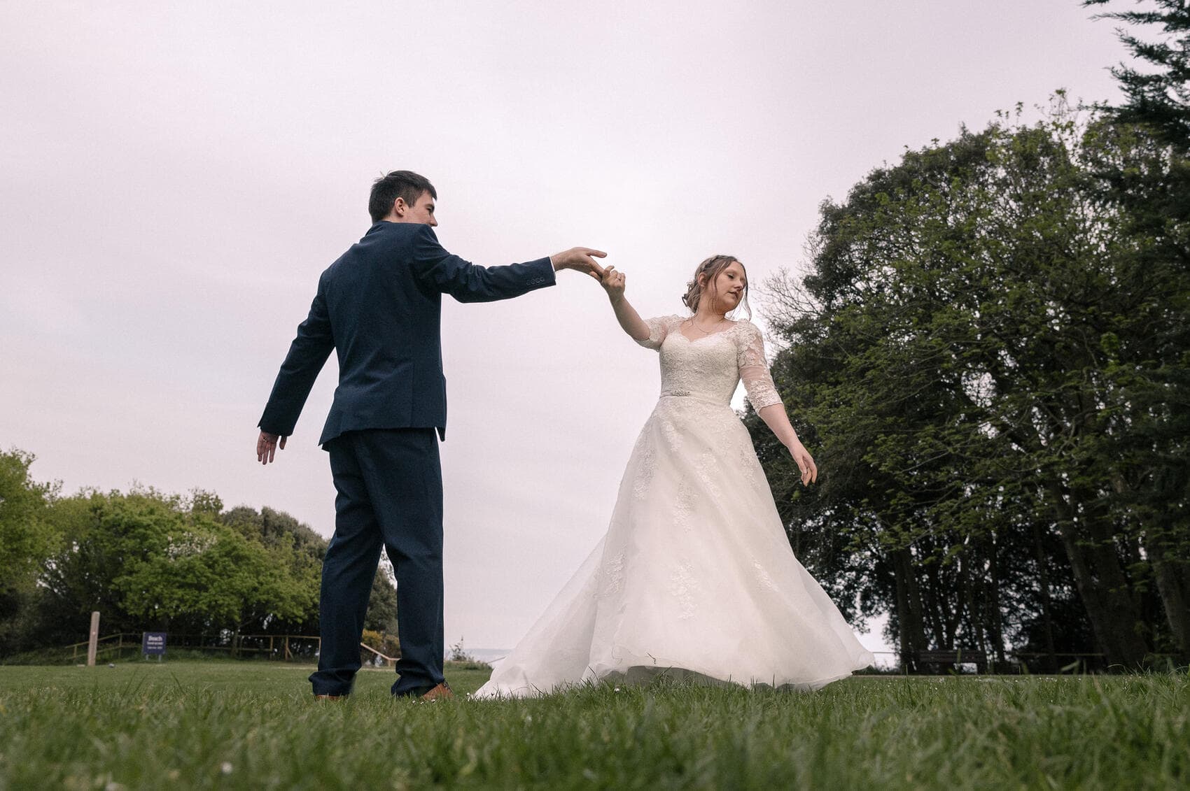 Bride and groom dance on the lawn of Highcliffe castle wedding