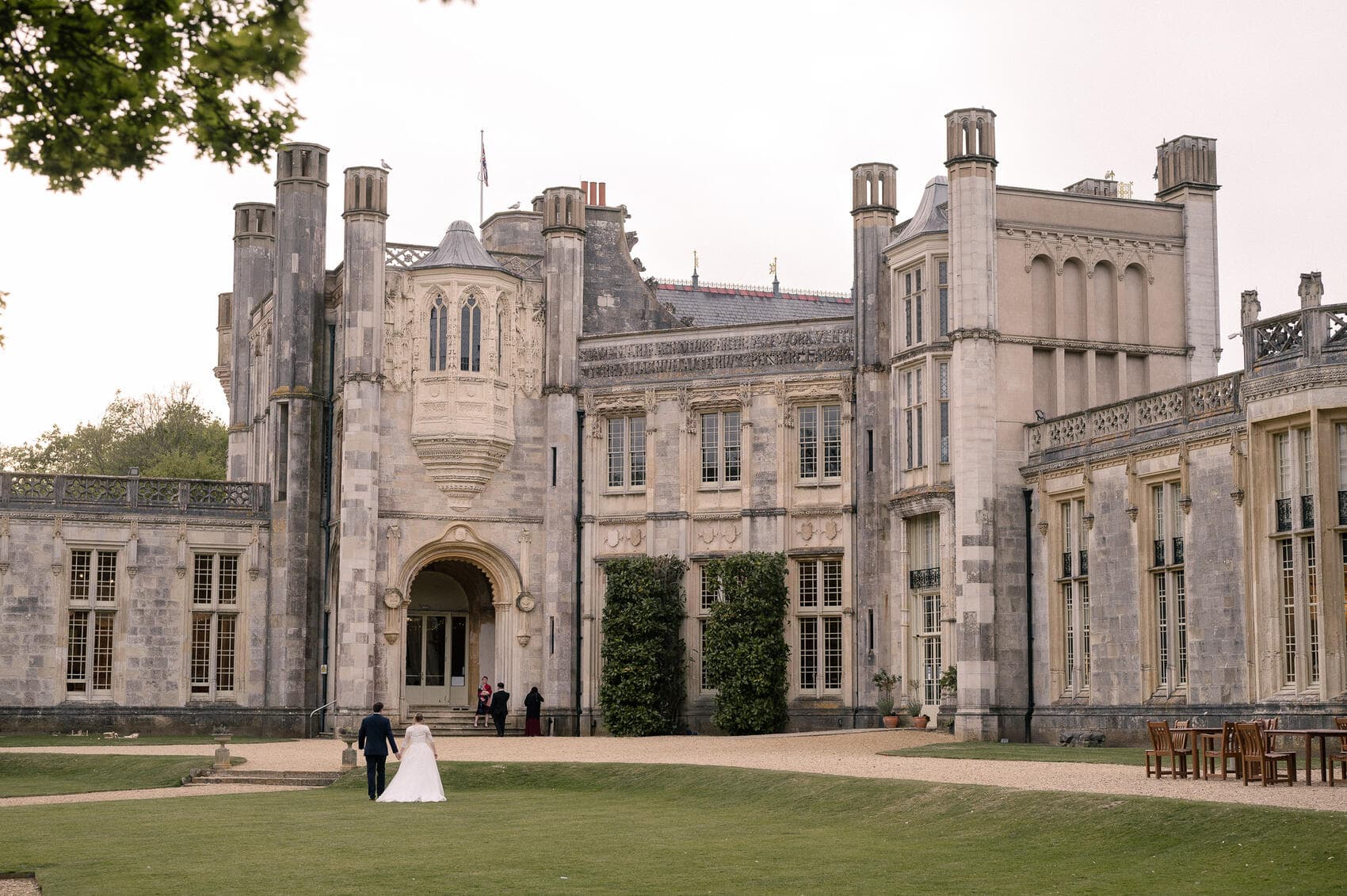 bride and groom walk the lawn at Highcliffe castle