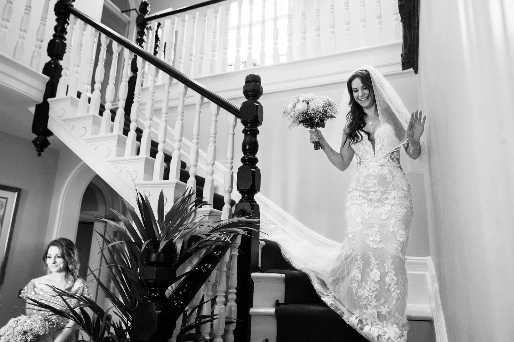 Bride comes down the staircase at Abbots Court wedding venue