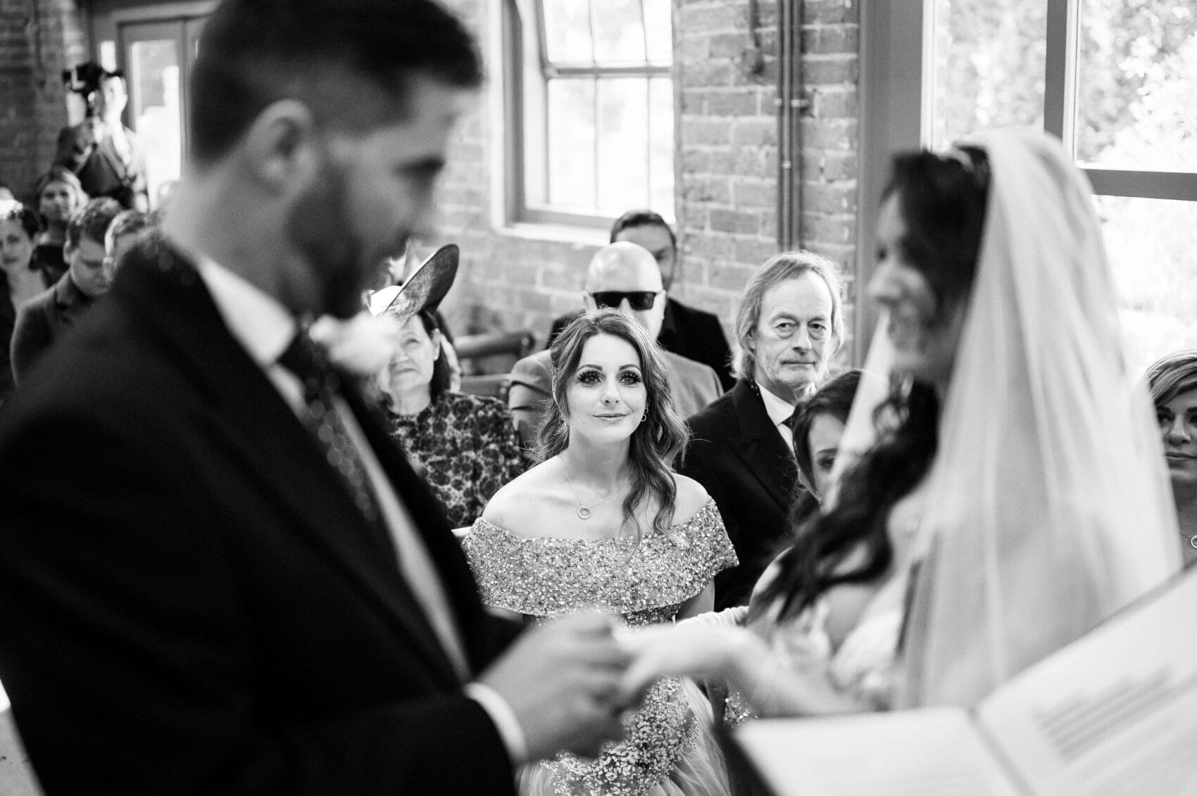 Bridesmaid watched the couple exchange rings