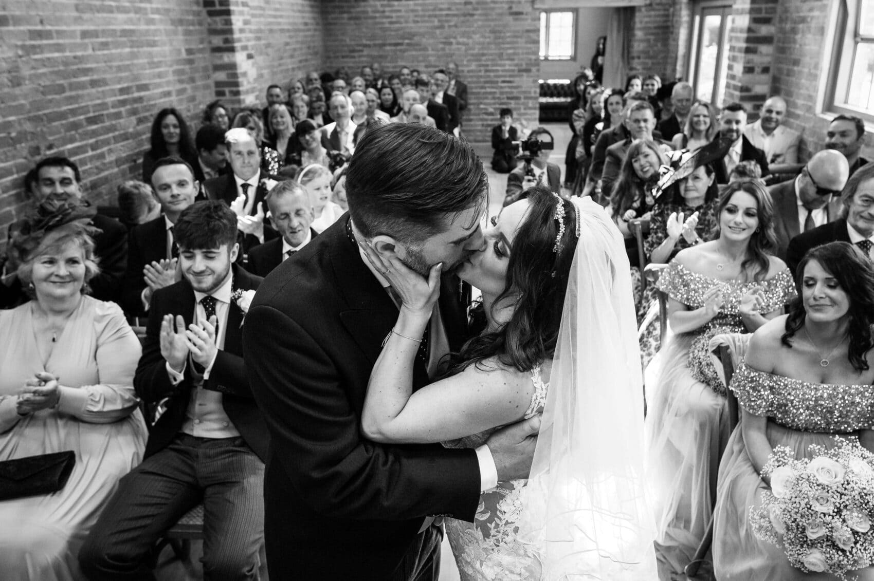 The ceremony kiss at Abbots Court wedding barn
