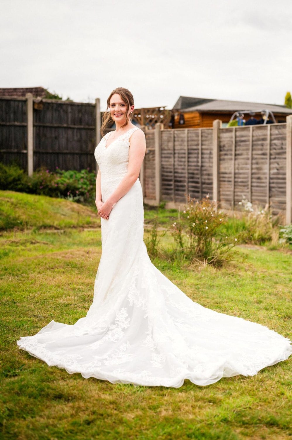 Bride in her dress in her garden on the day of her St Mary's Catholic Church wedding
