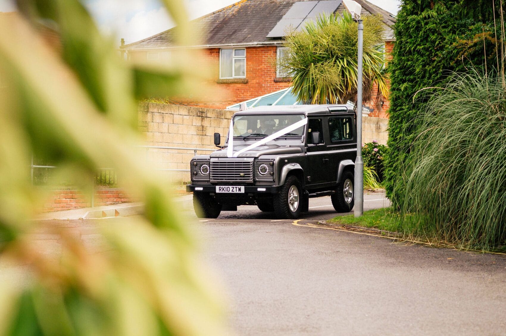 Land Rover defender arrives at St Mary's Catholic Church with the bride