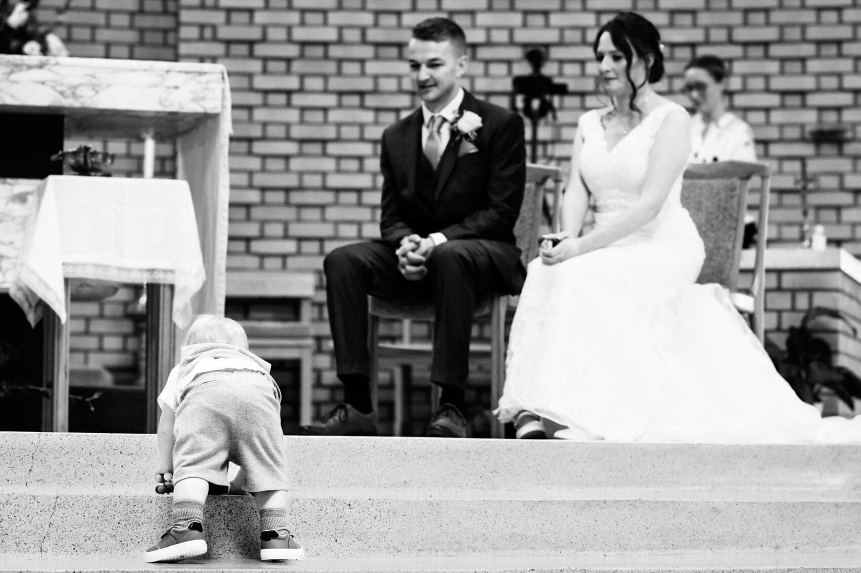 Paige Boy climbs the step at the front of St Mary's Catholic Church to see the bride and groom