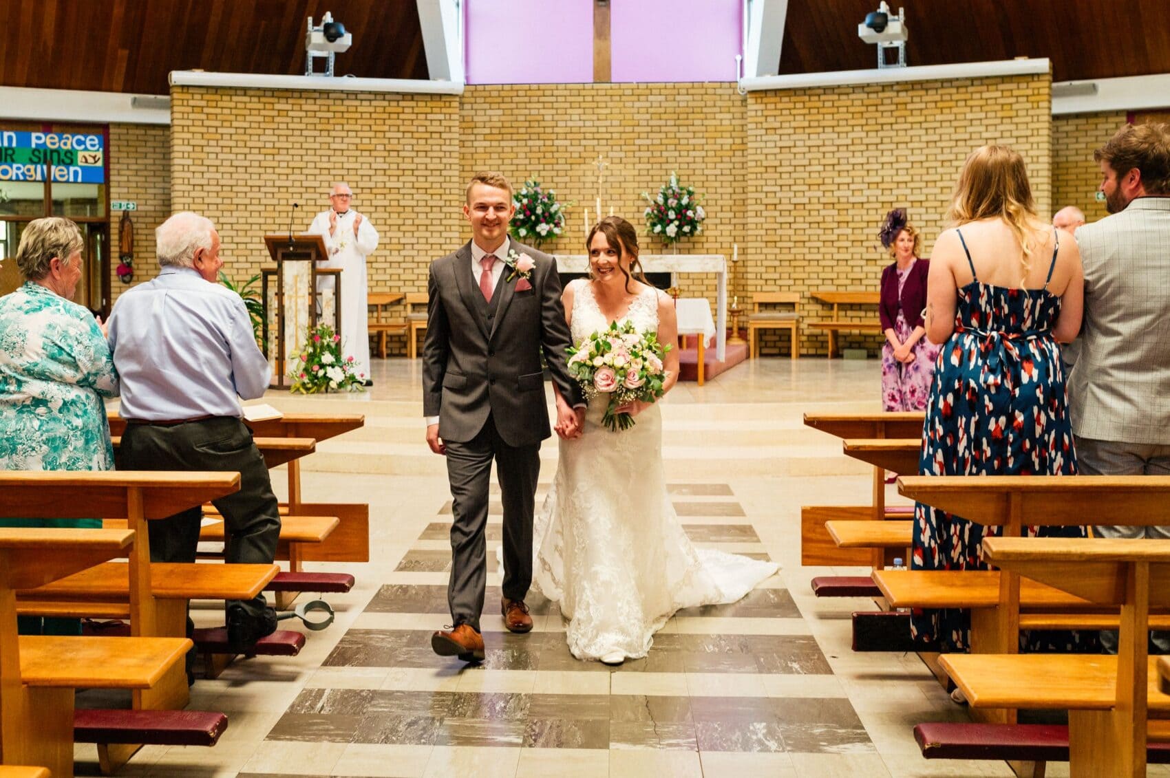 Megan and Ben exit the wedding ceremony at St Mary's Catholic Church