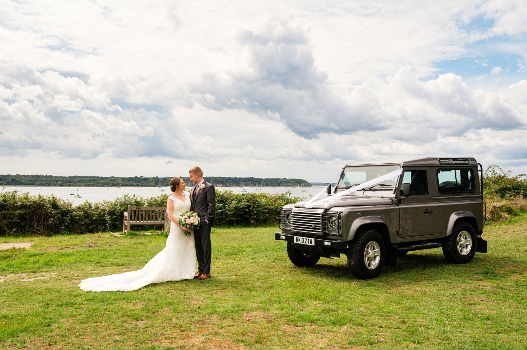 Bride and Groom with Land Rover Defender on Evening hill Poole
