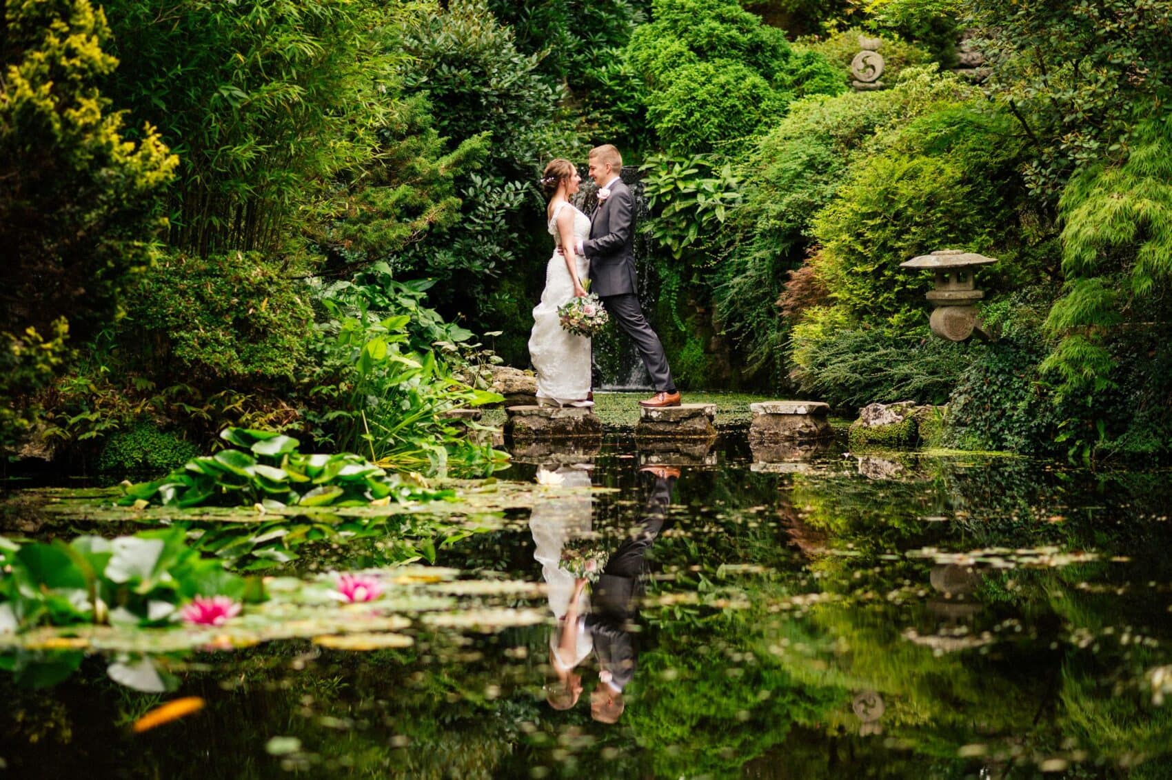 Bride and Groom on stepping stones at the The Italian Villa, Poole