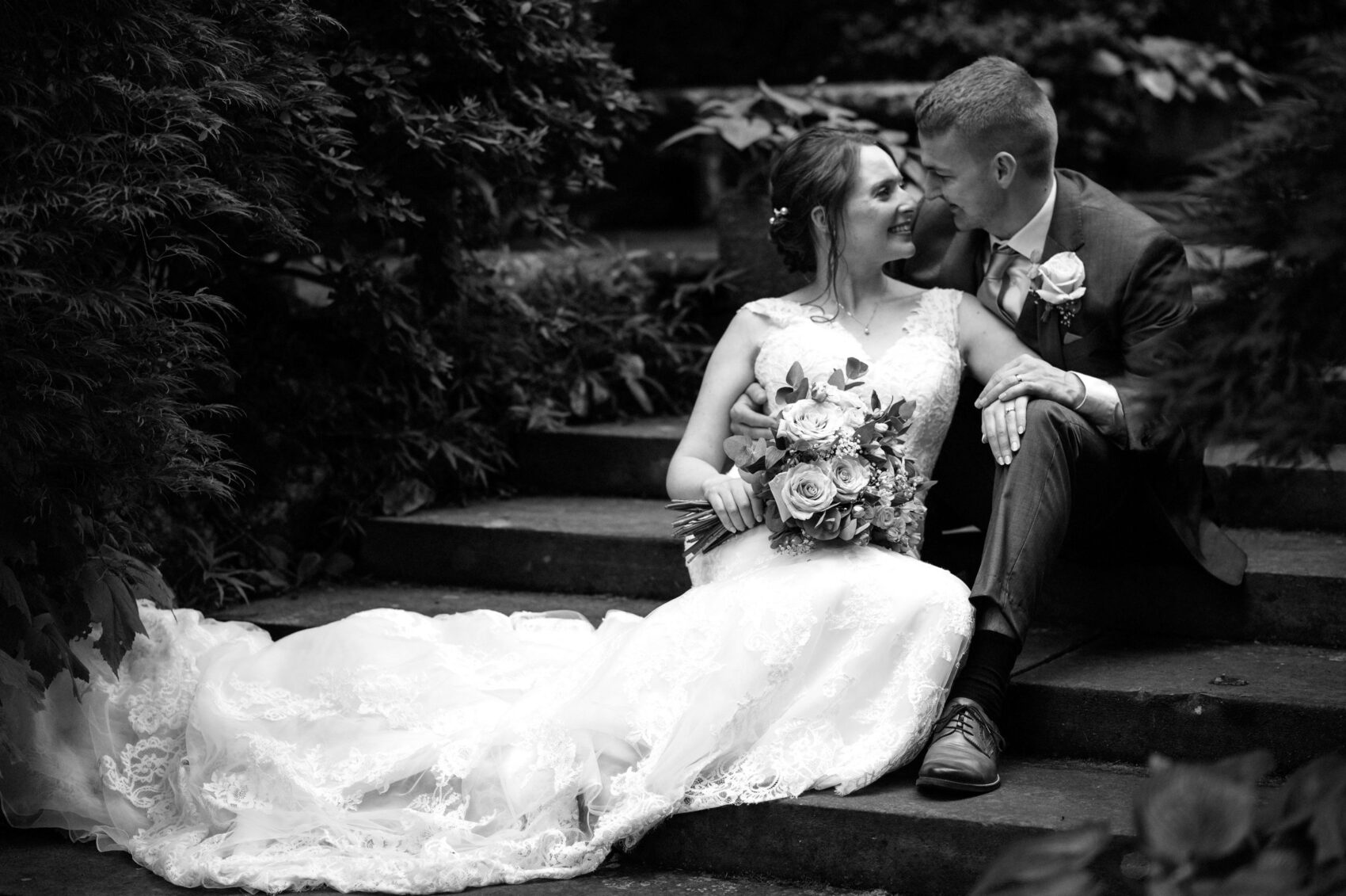 Bride and groom in B&W on the steps of the Japanese garden in The Italian Villa in Poole