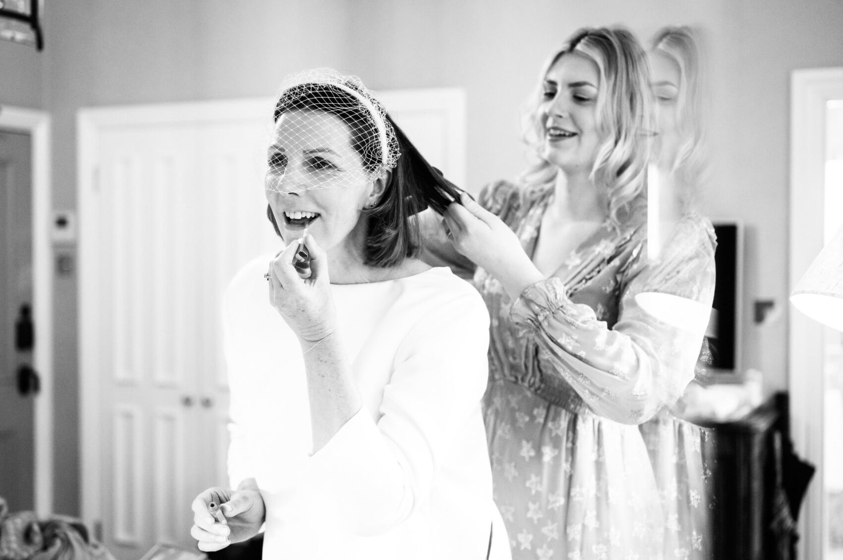 Daughter doing mums hair on wedding day