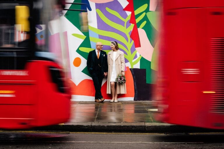 London busses pass bride and groom at Kensington and Chelsea Registry office wedding