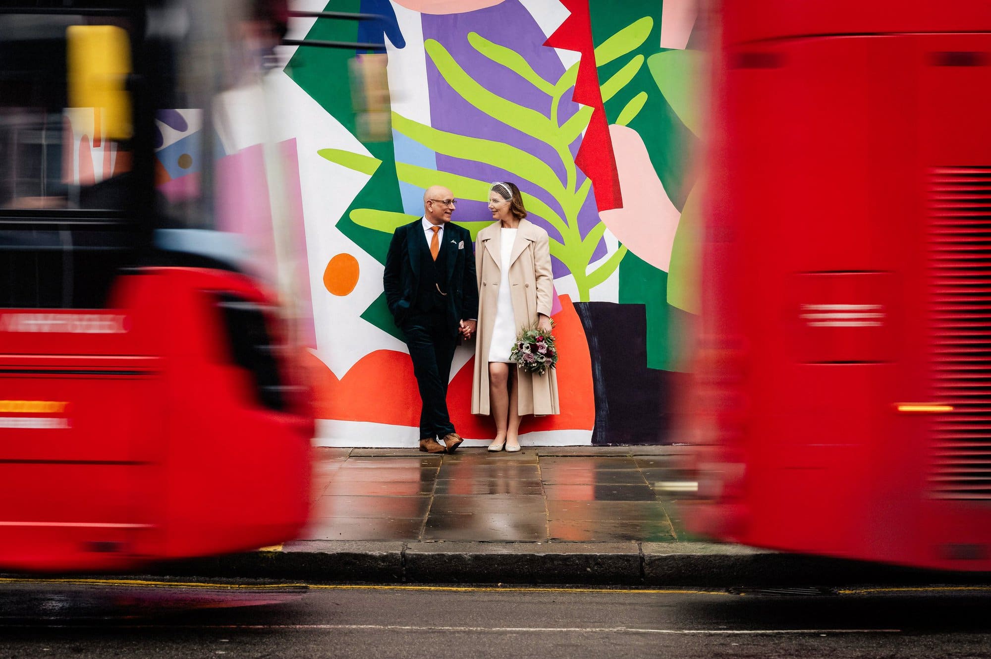 London busses pass bride and groom at Kensington and Chelsea Registry office wedding