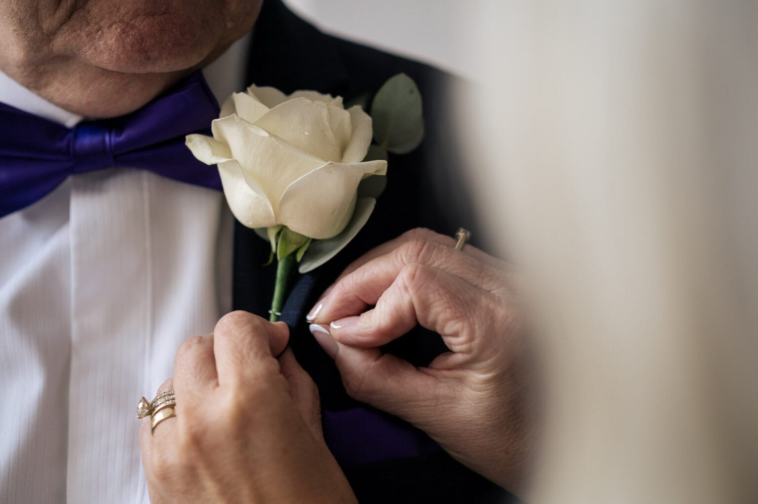 Father of the bride has a rose pinned to his suit
