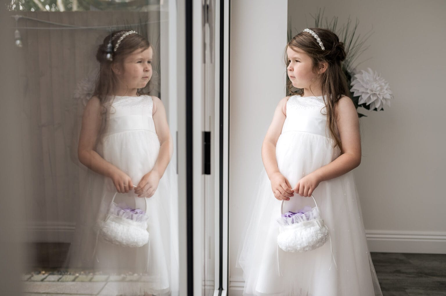 Flowergirl looks out of the window with a relection