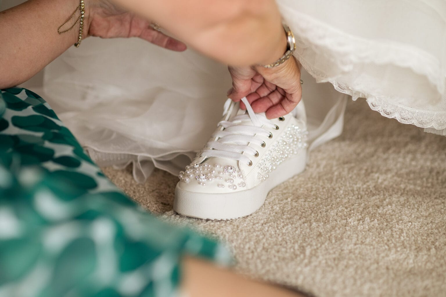 Bride putting on her Nike Air Force shoes