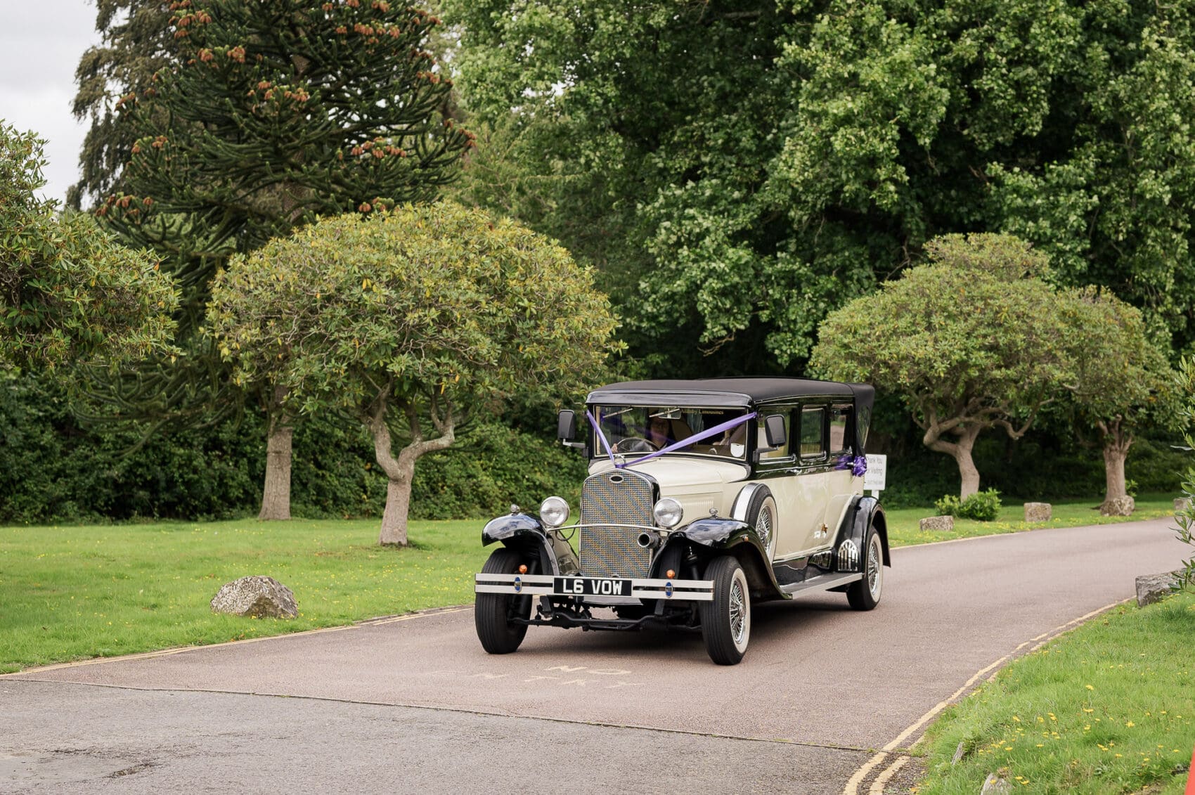Bride arrives at Chilworth Manor Hotel wedding in a vintage car