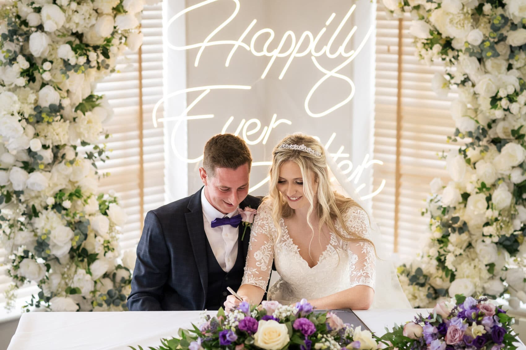 Couple sign the register at their Chilworth Manor Hotel wedding