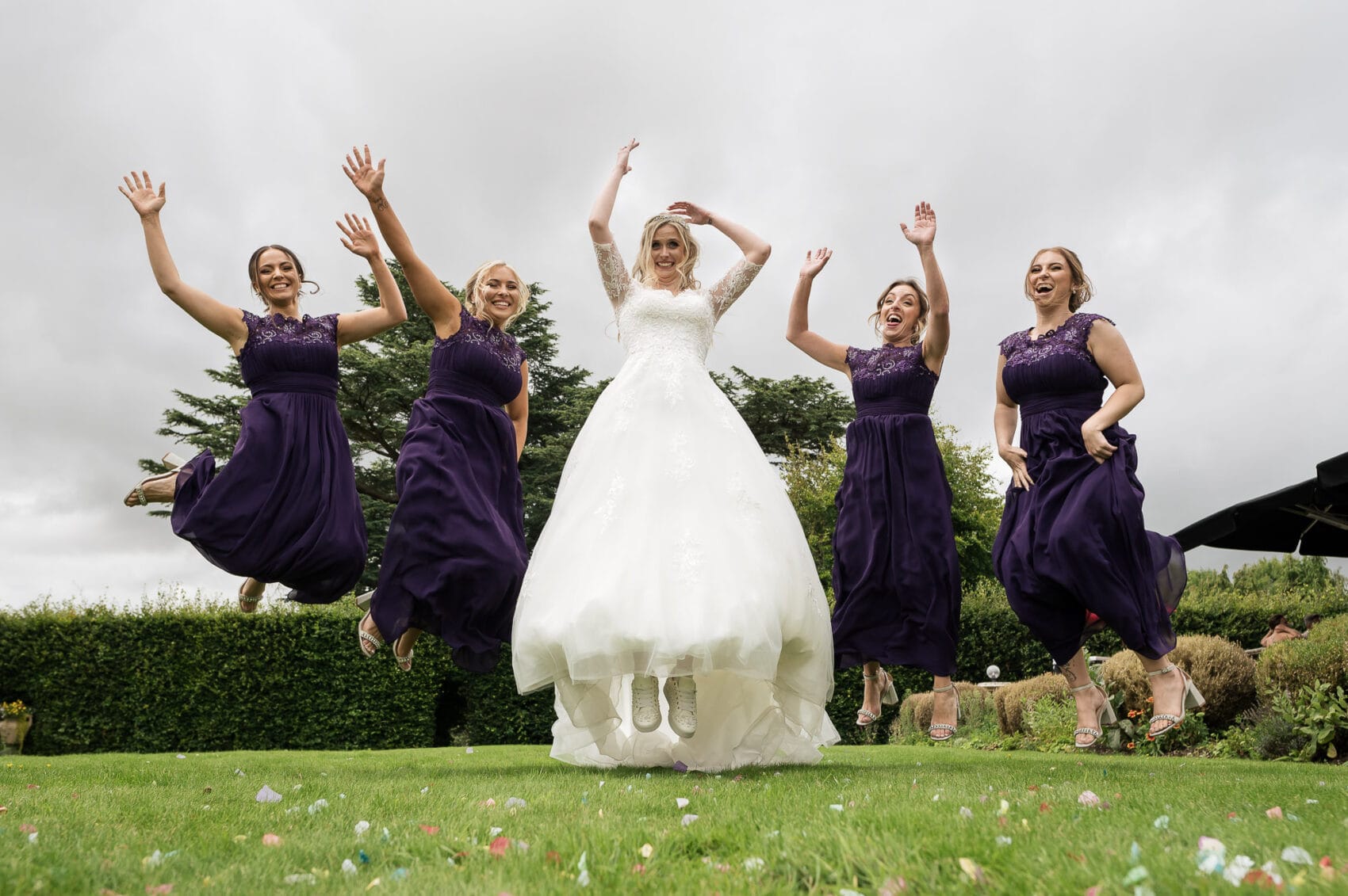 Bride and her bridemaids jump for a photo