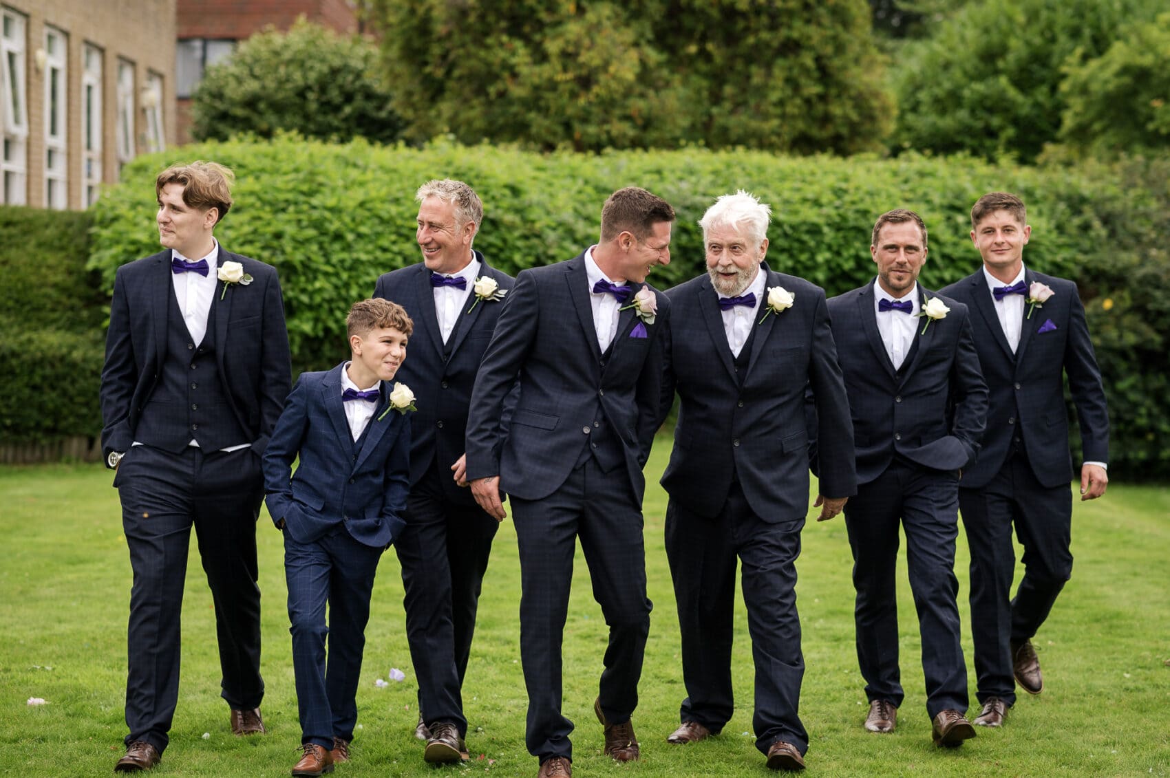 Groom and the groomsmen take a strool on the lawn at Chilworth Manor Hotel wedding