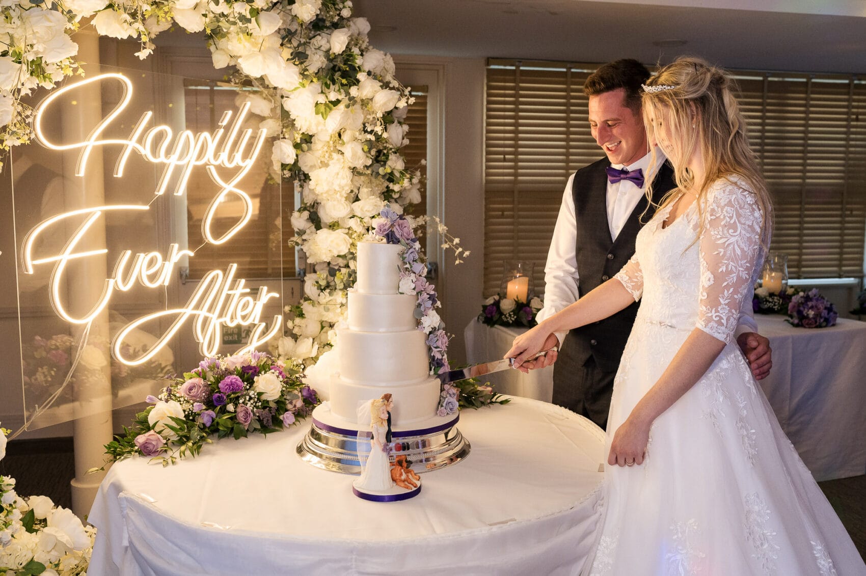 Bride and groom cut their cake at Chilworth Manor Hotel wedding