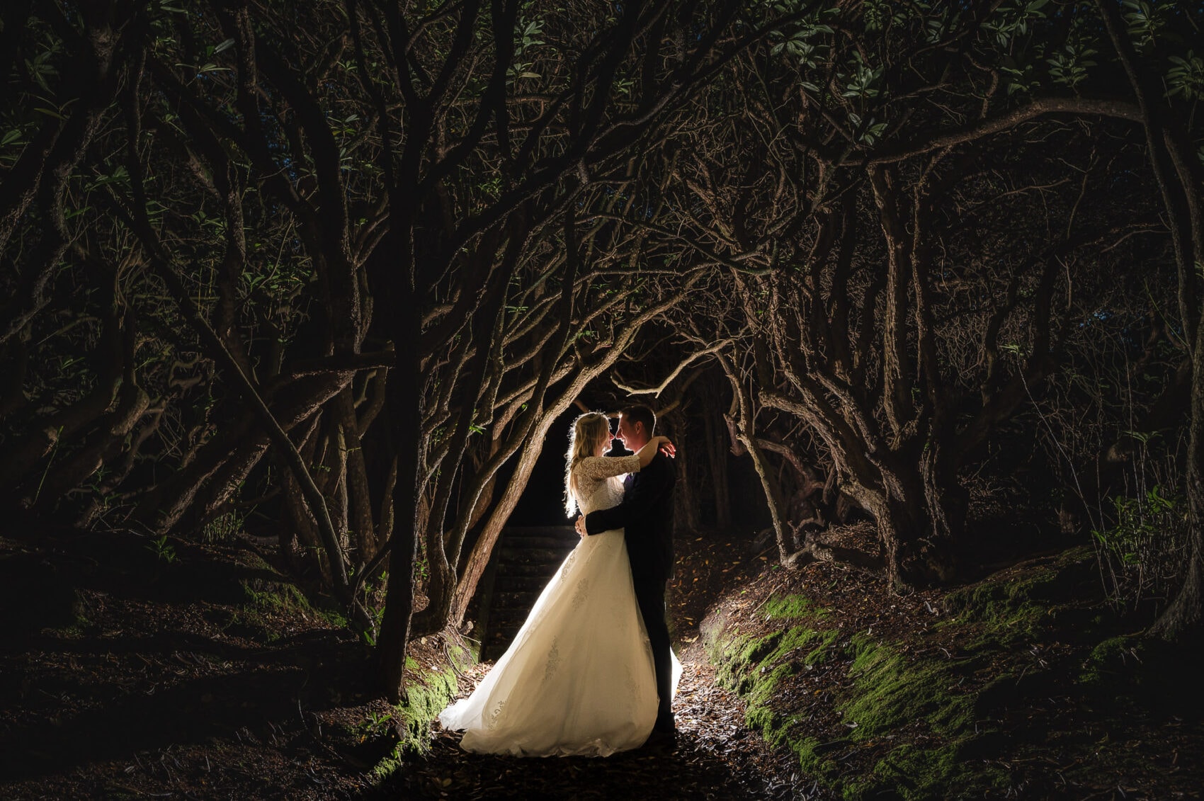 Bride and Groom pose in the Woodland at their Chilworth Manor Hotel wedding