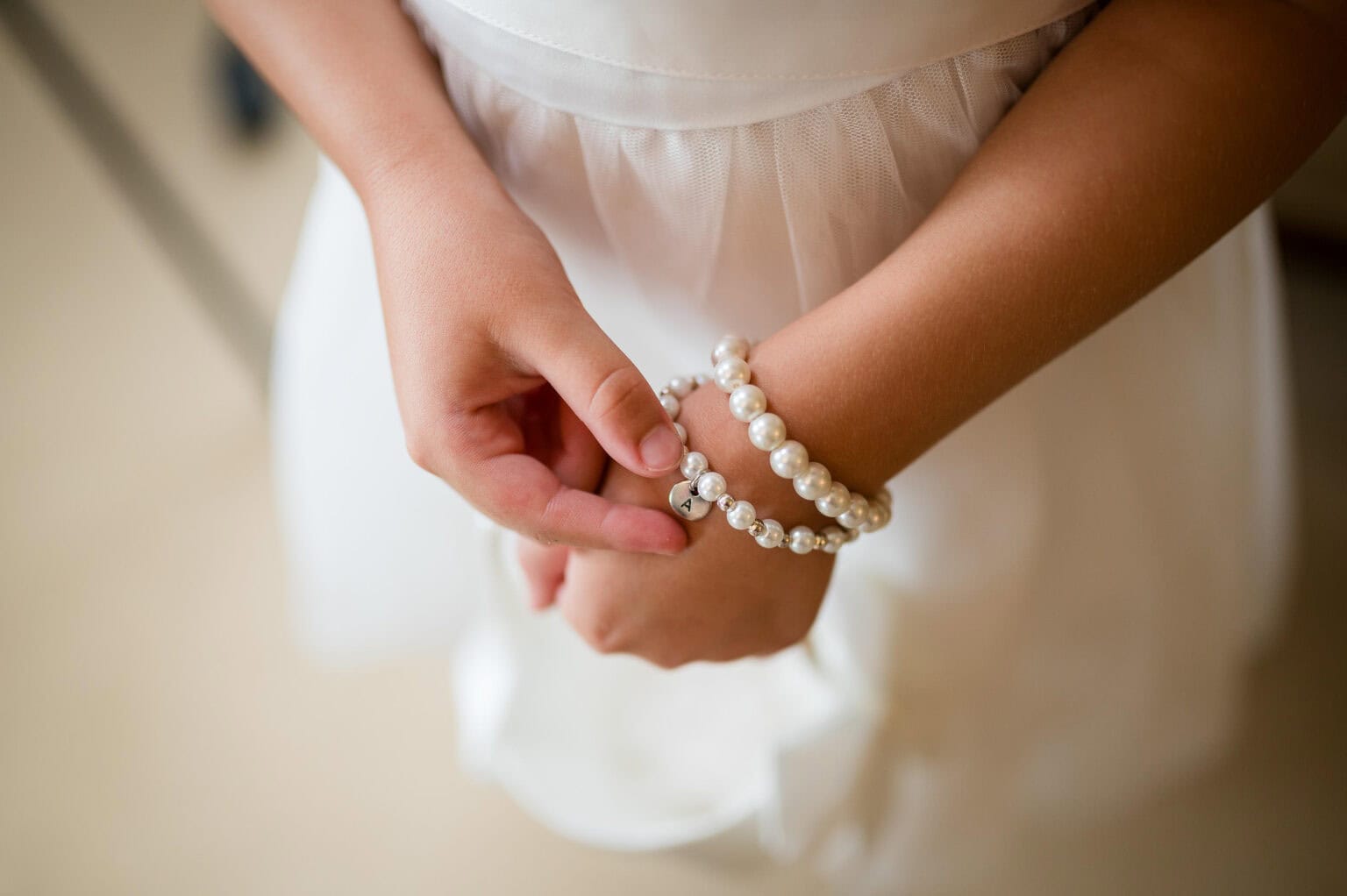 Flowergirl adjusting her gift of a bracelet