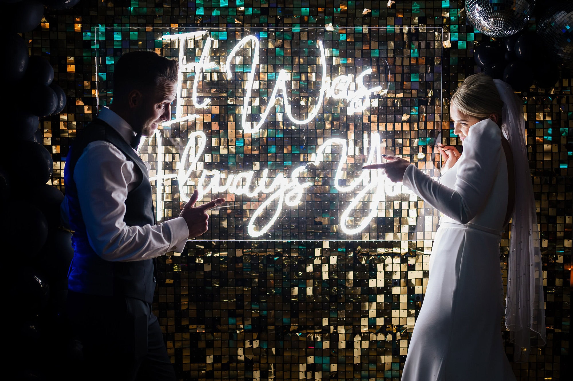 Bride and Groom standing in front of a sign saying It was always you at the Kings Hotel in Christchurch