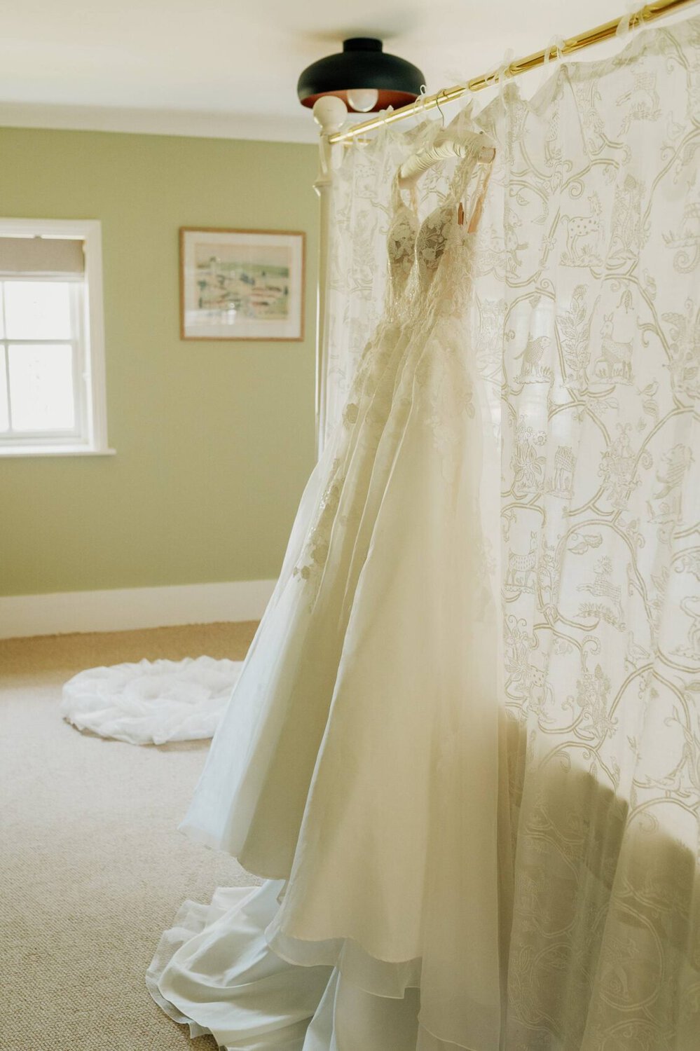 Wedding dress hanging on bed at Hale Park House Wedding