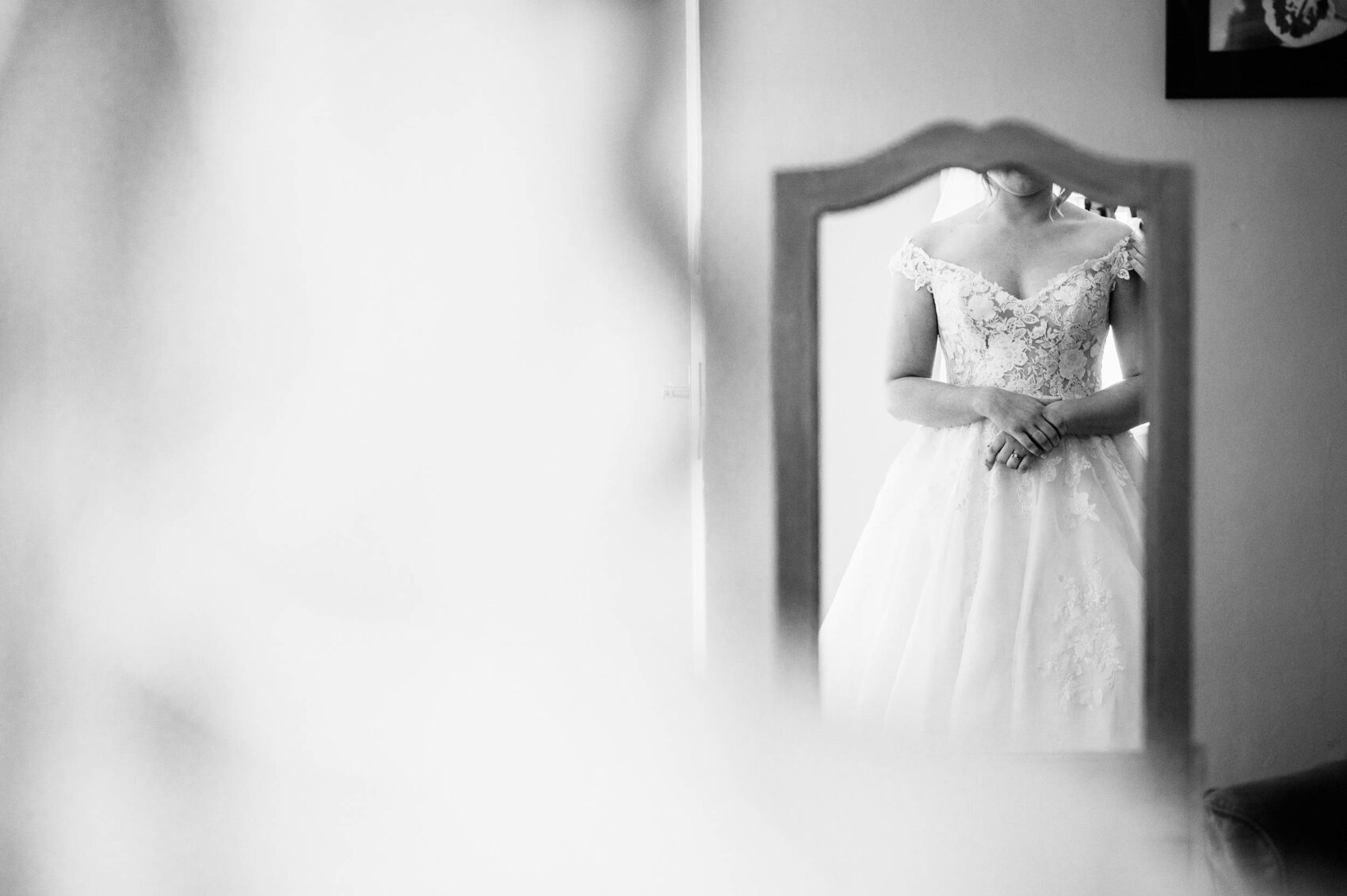 brides last look at the dress during preparation