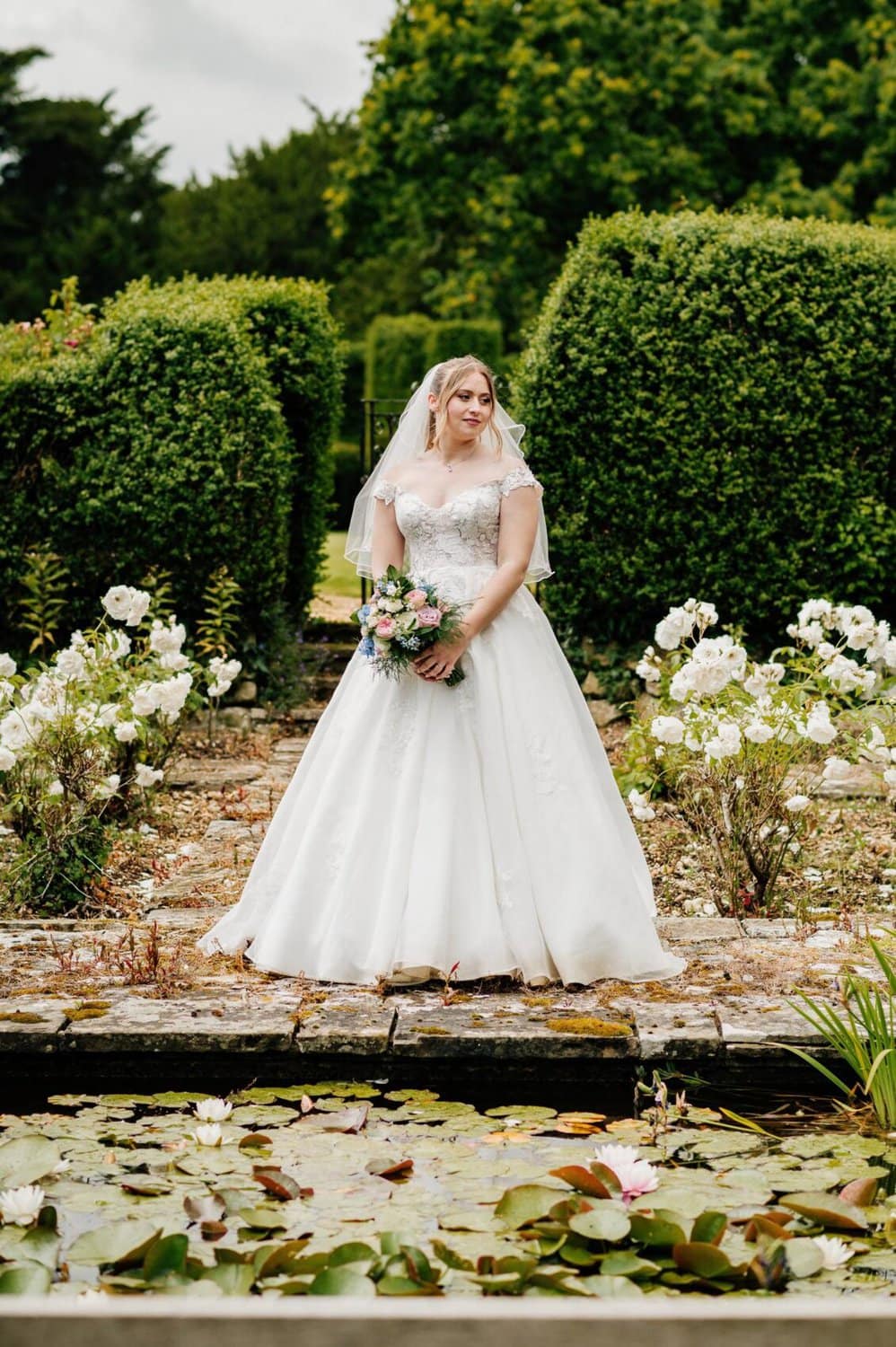 Bride in the rose garden at Hale Park House Wedding