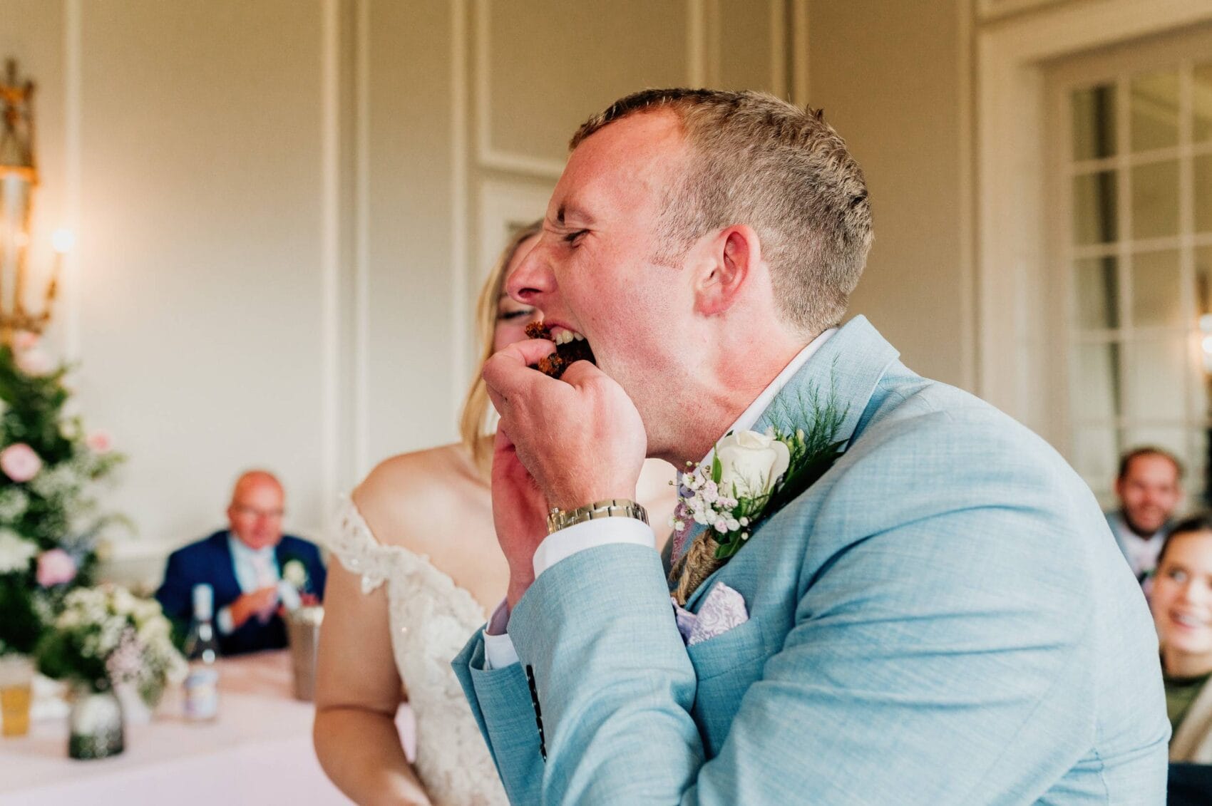 groom eats the cake at hale park house wedding